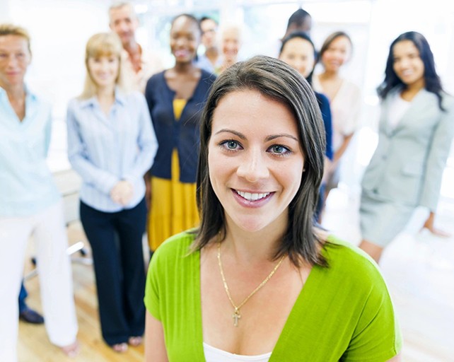 Beautiful young woman with colleagues