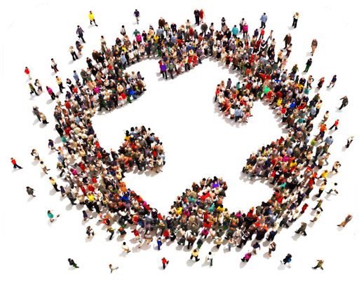 Many people forming a giant puzzle piece